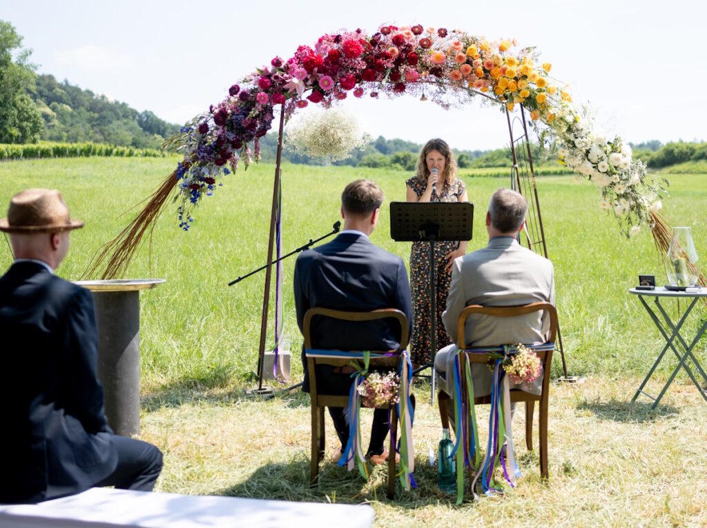 Hochzeitszeremonie auf der Wiese im Weingut Clauer